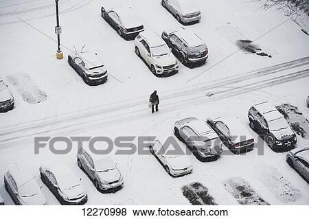 Cars covered in snow in downtown parking lot; Toronto, Ontario, Canada View Large Photo Image Stock Photo - Cars covered in snow in downtown parking lot; Toronto, Ontario, Canada. Fotosearch