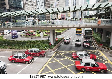 Central distict in Hong Kong Island, gateways, red taxis and a crowd of people; Hong Kong, China View Large Photo Image Stock Photo - Central distict in Hong Kong Island, gateways, red taxis and a crowd of people; Hong Kong, China. Fotosearch