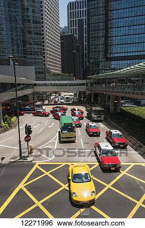 Central district on Hong Kong Island, with gateways, red taxi and a crowd of people; Hong Kong, China View Large Photo Image Stock Photograph - Central district on Hong Kong Island, with gateways, red taxi and a crowd of people; Hong Kong, China. Fotosearch