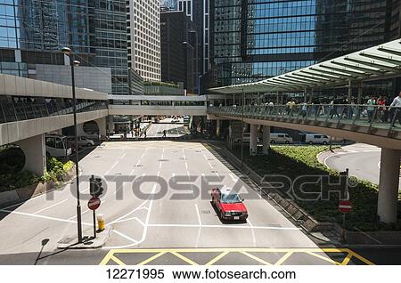 Central district on Hong Kong Island, with gateways, red taxi and a crowd of people; Hong Kong, China View Large Photo Image Stock Photography - Central district on Hong Kong Island, with gateways, red taxi and a crowd of people; Hong Kong, China. Fotosearch
