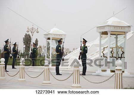 Stock Image - Changing the guard at the Monument of Neutrality; Ashgabat, Turkmenistan. Fotosearch