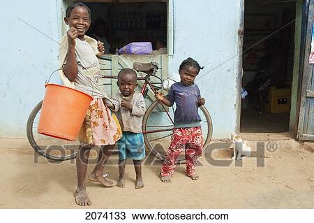 Children & Cat In Front Of A Bar In Ambalavao, Fianarantsoa Province, Madagascar View Large Photo Image Stock Image - Children & Cat In Front Of A Bar In Ambalavao, Fianarantsoa Province, Madagascar. Fotosearch