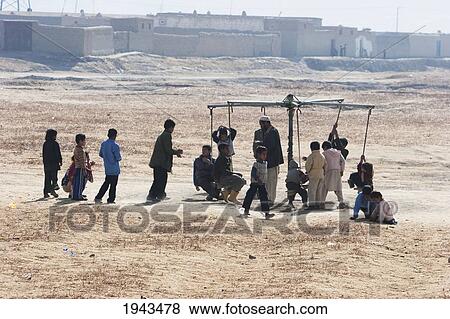 Children Playing At A Merry-Go-Round In Kabul,, Afghanistan View Large Photo Image Stock Photo - Children Playing At A Merry-Go-Round In Kabul,, Afghanistan. Fotosearch