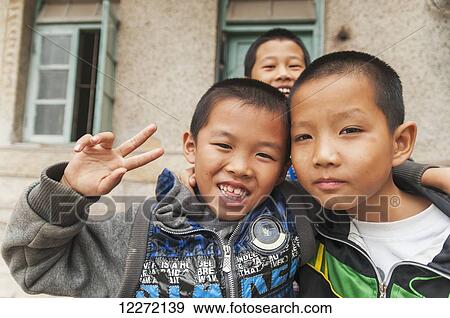 Stock Photo - Children posing for a picture; Xiamen, Fujian province, China. Fotosearch