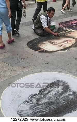 Stock Photography - Chinese man painting Mona Lisa on the ground; Wuhan, Hubei province, China. Fotosearch