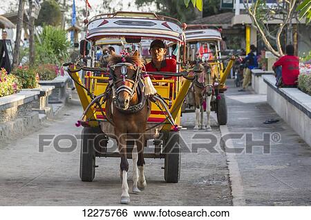 Stock Photograph - Cidomo, a horse-drawn carriage, Gili Trawangan, West Nusa Tenggara, Indonesia. Fotosearch