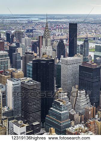 Cityscape of New York City with skyscrapers in Manhattan and the spire of the Chrysler building; New York City, New York, United States of America View Large Photo Image Stock Photograph - Cityscape of New York City with skyscrapers in Manhattan and the spire of the Chrysler building; New York City, New York, United States of America. Fotosearch