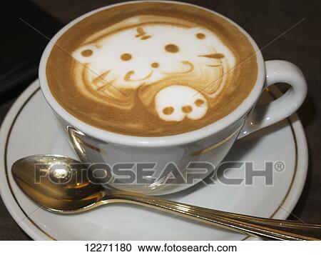 Stock Image - Close up of a cappuccino with cute bear design in the foam; Kyoto, Japan. Fotosearch