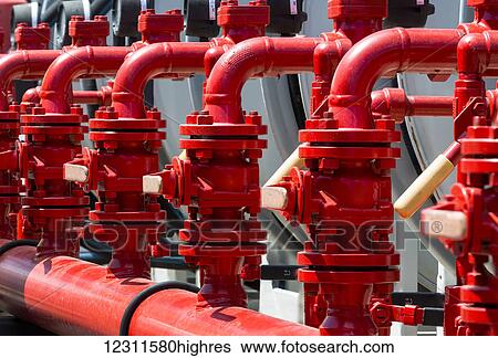 Stock Photograph - Close up of a clean newly painted row of shut off values and pipes; Calgary, Alberta, Canada. Fotosearch