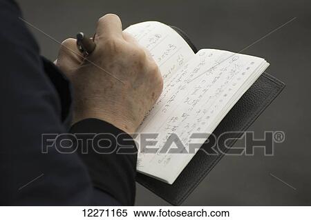 Close up of a person taking notes in Japanese; Kyoto, Japan View Large Photo Image Stock Photography - Close up of a person taking notes in Japanese; Kyoto, Japan. Fotosearch