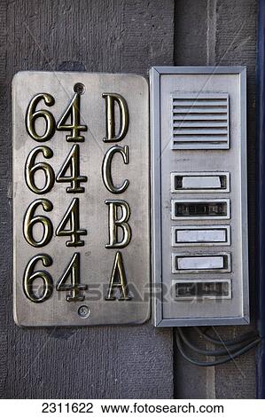 Stock Image - Close-up of apartment intercom numbers and buzzers. Fotosearch