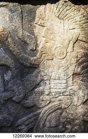 Close up of detailed stone carving of Mayan warrior holding head; Chichen Itza, Yucatan, Mexico View Large Photo Image Picture - Close up of detailed stone carving of Mayan warrior holding head; Chichen Itza, Yucatan, Mexico. Fotosearch
