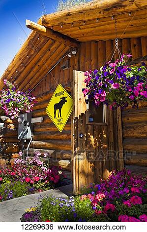 Stock Photograph - Close up of Log Cabin Visitor Information Center in downtown Anchorage, Southcentral Alaska, Summer.. Fotosearch