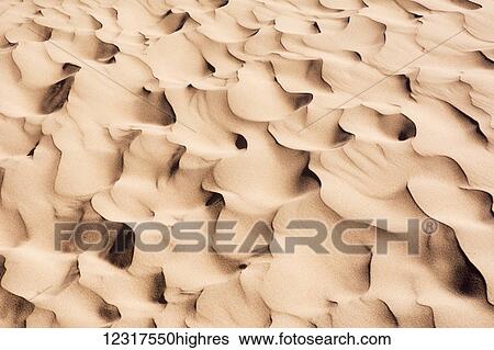 Close up of sand dune pattern looks like waves of sand; Mendoza, Argentina View Large Photo Image Stock Photograph - Close up of sand dune pattern looks like waves of sand; Mendoza, Argentina. Fotosearch