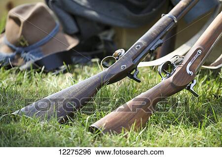 Close up of two American Civil War rifles with their buts in the grass, a hat and other clothes in the background; United States of America View Large Photo Image Stock Photograph - Close up of two American Civil War rifles with their buts in the grass, a hat and other clothes in the background; United States of America. Fotosearch