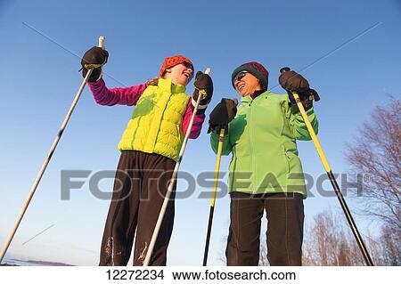 Close up of two people cross country skiing on the Tony Knowles Coastal Trail, Southcentral Alaska View Large Photo Image Picture - Close up of two people cross country skiing on the Tony Knowles Coastal Trail, Southcentral Alaska. Fotosearch