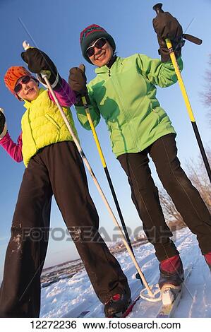 Stock Photograph - Close up of two people cross country skiing on the Tony Knowles Coastal Trail, Southcentral Alaska. Fotosearch