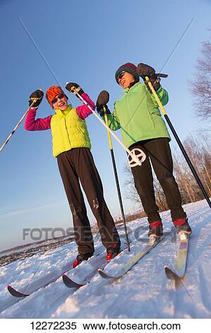 Stock Photography - Close up of two people cross country skiing on the Tony Knowles Coastal Trail, Southcentral Alaska. Fotosearch