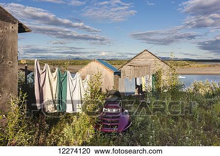 Stock Image - Clothes hang on a clothesline between houses and along the Noatak River, Noatak, Arctic Alaska, USA, Summer . Fotosearch