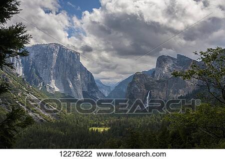 Clouds move over Yosemite Valley, with Bridalveil Falls on the right and El Capitan on the left, Yosemite National Park; California, United States of America View Large Photo Image Stock Image - Clouds move over Yosemite Valley, with Bridalveil Falls on the right and El Capitan on the left, Yosemite National Park; California, United States of America. Fotosearch