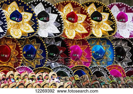 Stock Image - Colourful Mexican sombreros, Mayan masks and Mexican dolls on display; Chichen Itza, Yucatan, Mexico. Fotosearch