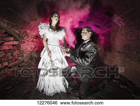 Couple dressed in costumes at Halloween; Tarifa, Cadiz, Andalusia, Spain View Large Photo Image Stock Photograph - Couple dressed in costumes at Halloween; Tarifa, Cadiz, Andalusia, Spain. Fotosearch