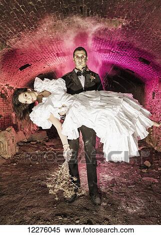 Stock Photography - Couple dressed in costumes at Halloween; Tarifa, Cadiz, Andalusia, Spain. Fotosearch