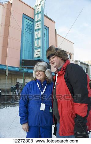 Couple stand in front of the historic 4th Avenue Theater and enjoy the pre-race activities of the 2011 Iditarod, Anchorage, Alaska View Large Photo Image Stock Photo - Couple stand in front of the historic 4th Avenue Theater and enjoy the pre-race activities of the 2011 Iditarod, Anchorage, Alaska. Fotosearch