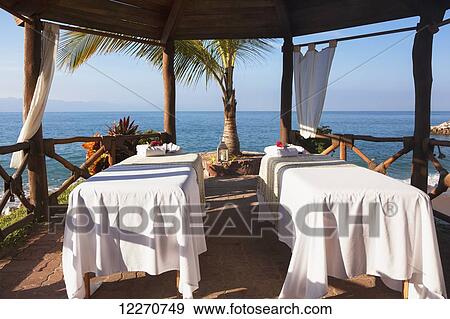 Stock Photo - Couples massage tables set up on the beach; Puerto Vallarta, Jalisco, Mexico. Fotosearch