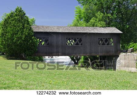 Covered bridge over La Chute Riverwalk, connecting Lake George to Lake Champlain; Ticonderoga, New York, United States of America View Large Photo Image Stock Image - Covered bridge over La Chute Riverwalk, connecting Lake George to Lake Champlain; Ticonderoga, New York, United States of America. Fotosearch