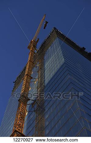 Stock Photo - Crane lifting a generator to the top of the Bay Adelaide Centre under construction; Toronto, Ontario, Canada. Fotosearch