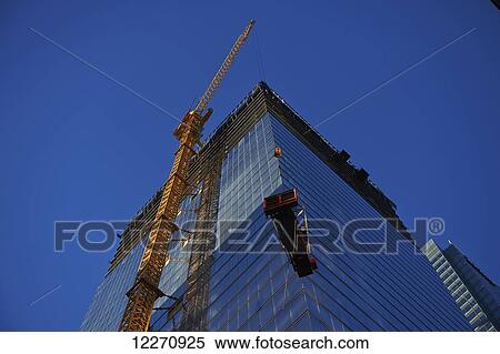 Stock Photography - Crane lifting a generator to the top of the Bay Adelaide Centre under construction; Toronto, Ontario, Canada. Fotosearch