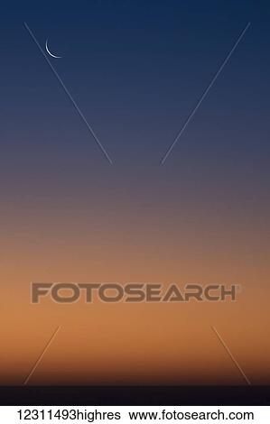 Stock Photograph - Cresecent moonrise over the ocean; South Africa. Fotosearch