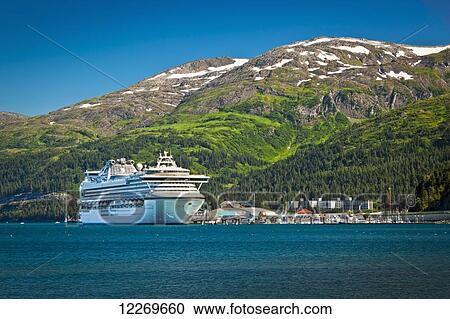 Stock Image - Cruise ship 'Diamond Princess' docked at the Port of Whittier surrounded by Chugach Mountains, Southcentral Alaska, Summer.. Fotosearch