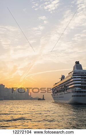Cruise ship in the harbour at sunset, Kowloon; Hong Kong, China View Large Photo Image Picture - Cruise ship in the harbour at sunset, Kowloon; Hong Kong, China. Fotosearch
