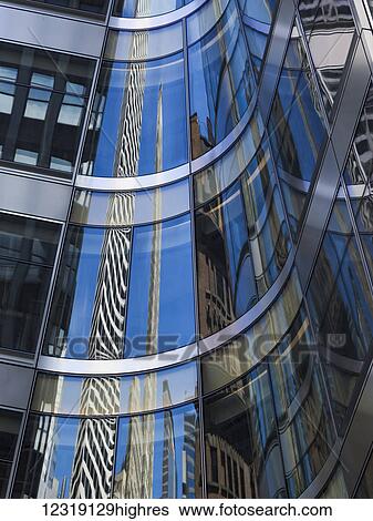 Curved glass facade of a building reflecting skyscrapers; New York City, New York, United States of America View Large Photo Image Stock Photograph - Curved glass facade of a building reflecting skyscrapers; New York City, New York, United States of America. Fotosearch