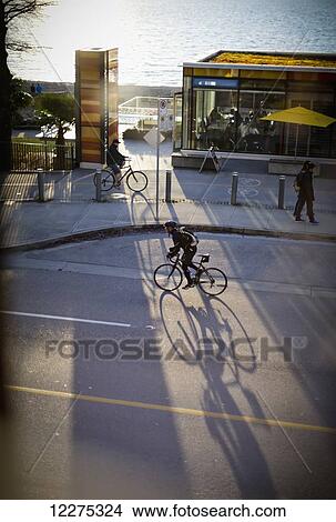 Picture - Cyclist at sunset by English Bay; Vancouver, British Columbia, Canada. Fotosearch