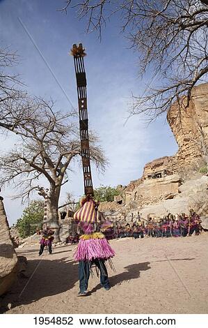 Stock Image - Dancers wearing Kananga masks perform at the Dama celebration in Tireli, Mali. Fotosearch