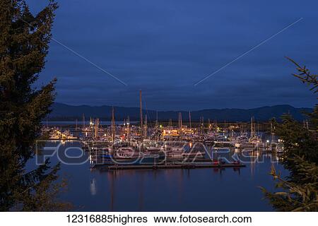 Stock Photograph - Darkness descends on the Port of Ilwaco; Ilwaco, Washington, United States of America. Fotosearch
