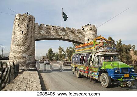 Stock Photograph - Decorated Pakistani Bus Passing Through Jamrud Gate To The Khyber Pass On The Outskirts Of Peshawar, Federally Administered Tribal Areas, Pakistan. Fotosearch
