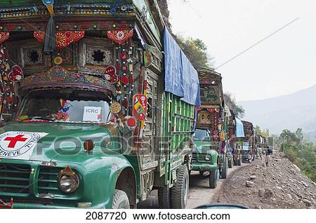 Stock Image - Decorated Pakistani Trucks Bringing Aid After The 8 October 2005 Earthquake, Subri, Azad Kashmir, Pakistan. Fotosearch