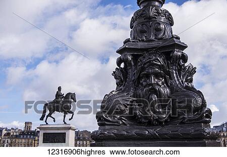 Decorative lamp post with Statue of Henri IV in the background; Paris, France View Large Photo Image Stock Photograph - Decorative lamp post with Statue of Henri IV in the background; Paris, France. Fotosearch