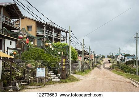 Dirt road lined with residential buildings; Punta del Diablo, Uruguay View Large Photo Image Stock Image - Dirt road lined with residential buildings; Punta del Diablo, Uruguay. Fotosearch