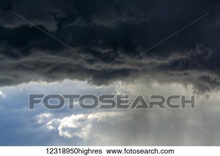 Dramatic dark storm cloud front with rain coming down; Calgary, Alberta, Canada View Large Photo Image Stock Photograph - Dramatic dark storm cloud front with rain coming down; Calgary, Alberta, Canada. Fotosearch