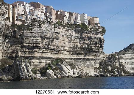 Dramatic view of houses on cliff from sea; Bonifacio, Corse-du-Sud, Corsica, France View Large Photo Image Stock Image - Dramatic view of houses on cliff from sea; Bonifacio, Corse-du-Sud, Corsica, France. Fotosearch
