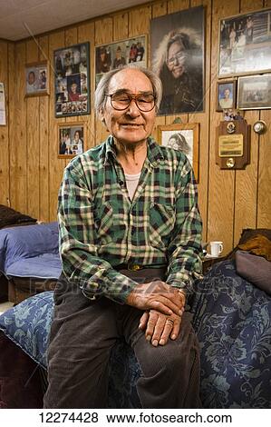 Elder Alaska native man sitting inside his home, Winter, Noatak, Arctic Alaska, USA View Large Photo Image Stock Photo - Elder Alaska native man sitting inside his home, Winter, Noatak, Arctic Alaska, USA. Fotosearch