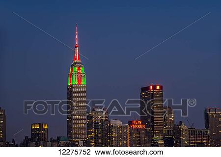 Empire State Building at twilight in colours celebrating Christmas; New York City, New York, United States of America View Large Photo Image Stock Image - Empire State Building at twilight in colours celebrating Christmas; New York City, New York, United States of America. Fotosearch