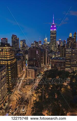 Stock Photo - Empire State Building at twilight, colours honouring the Military Order of the Purple Heart; New York City, New York, United States of America. Fotosearch