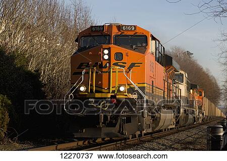 Stock Photo - Engine and train on railroad tracks; White Rock, British Columbia, Canada. Fotosearch