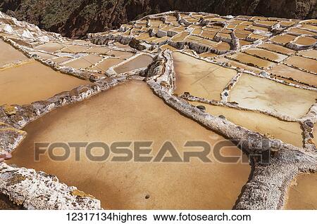 Stock Photograph - Family owned salt ponds in Sacred Valley near Urubama; Maras, Cusco, Peru. Fotosearch